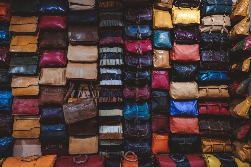 a large pile of different colored bags on display